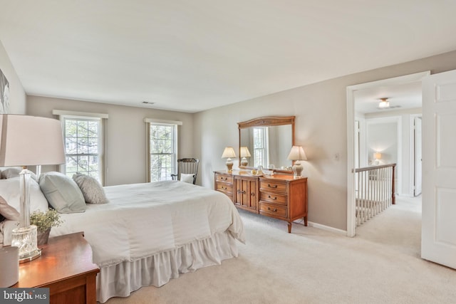 carpeted bedroom with baseboards and visible vents
