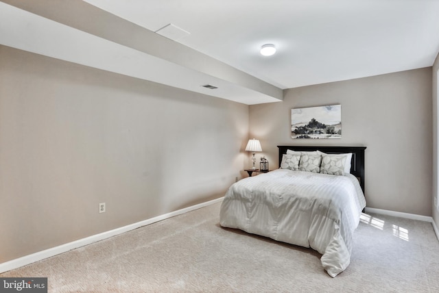 carpeted bedroom featuring visible vents and baseboards