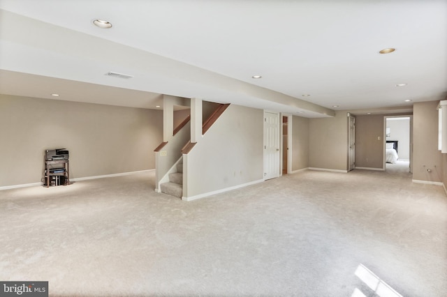 finished below grade area featuring recessed lighting, baseboards, visible vents, and light colored carpet