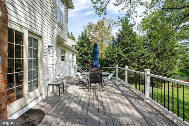 wooden deck featuring outdoor dining area