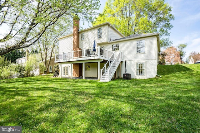 back of property featuring a lawn, central AC unit, a deck, and stairs