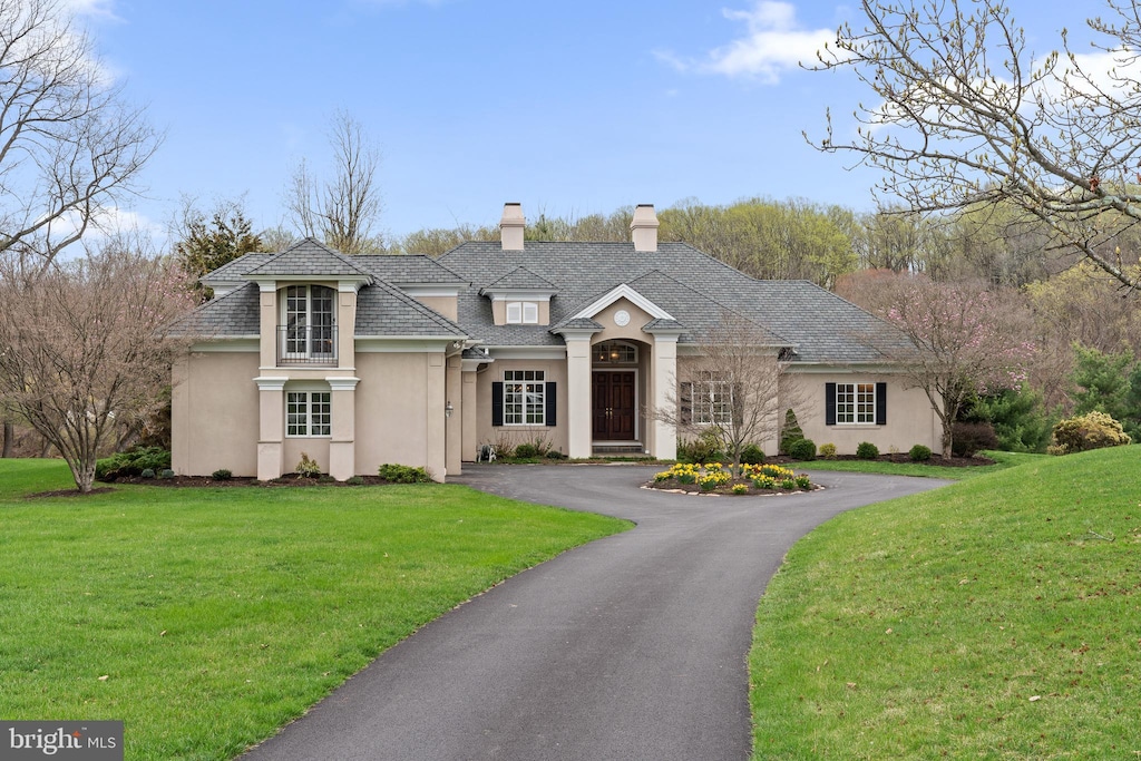 3 Zachary Dr, West Chester, PA 19382 - view of front facade with a chimney, a front lawn, driveway, and stucco siding