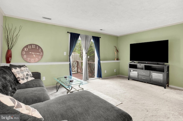 living area featuring visible vents, ornamental molding, baseboards, a textured ceiling, and carpet