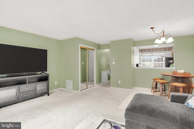 living area with carpet flooring, a notable chandelier, ornamental molding, and visible vents