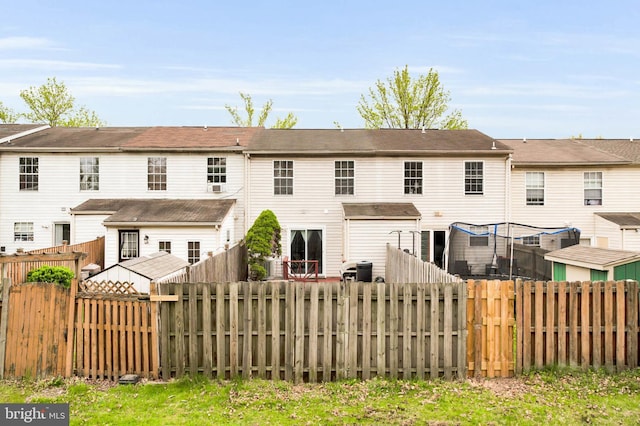 rear view of property with a fenced backyard