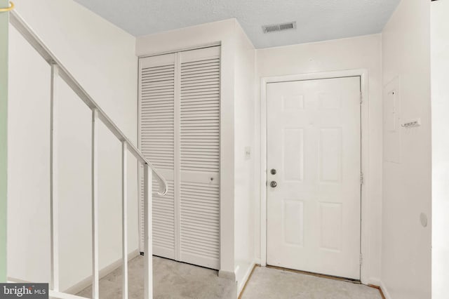 entryway with baseboards and visible vents