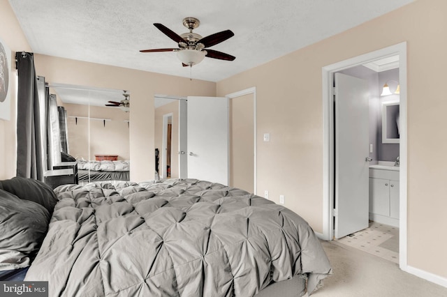 bedroom with carpet flooring, a ceiling fan, a textured ceiling, and baseboards
