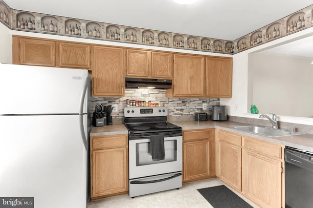kitchen with electric range, a sink, freestanding refrigerator, black dishwasher, and under cabinet range hood