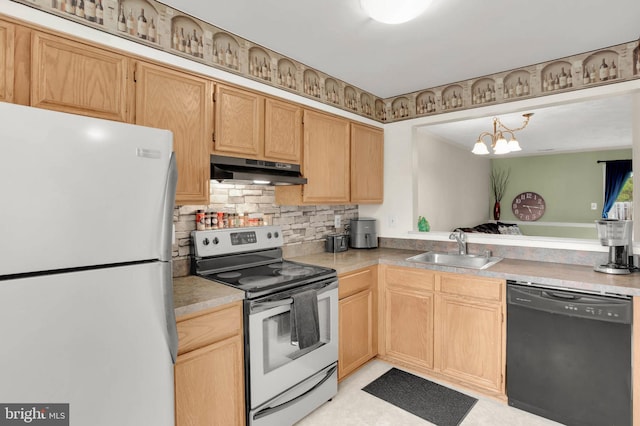 kitchen featuring stainless steel electric range, a sink, freestanding refrigerator, black dishwasher, and under cabinet range hood
