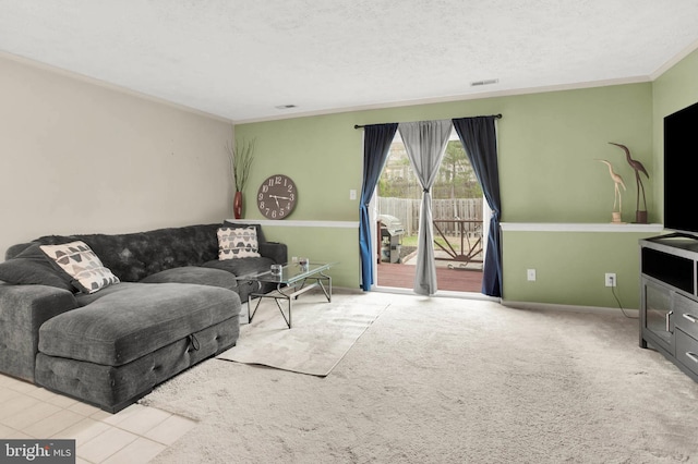 living area featuring a textured ceiling, visible vents, carpet floors, baseboards, and ornamental molding