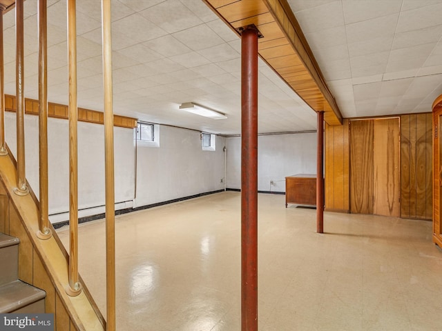 7147 Ohio Ave, Hanover, MD 21076 - basement with tile patterned floors, wood walls, and a baseboard heating unit
