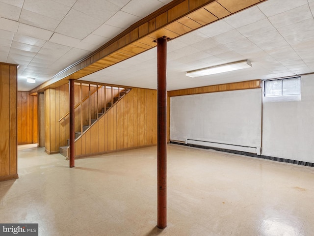 7147 Ohio Ave, Hanover, MD 21076 - basement featuring wooden walls, tile patterned floors, stairway, and a baseboard radiator