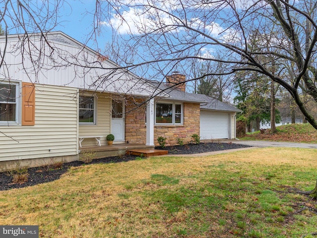7147 Ohio Ave, Hanover, MD 21076 - view of front facade with stone siding, a garage, a chimney, a front lawn, and driveway