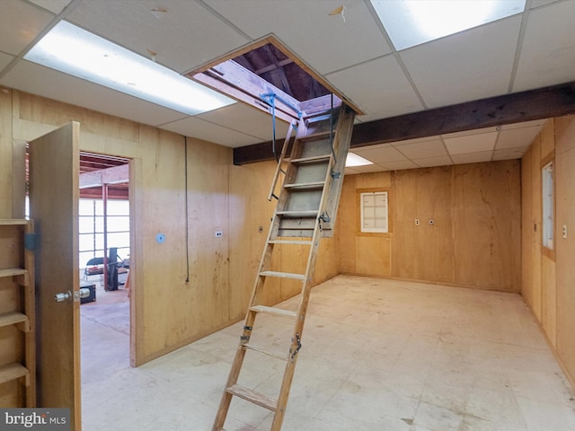 7147 Ohio Ave, Hanover, MD 21076 - basement featuring tile patterned floors, wood walls, and a drop ceiling