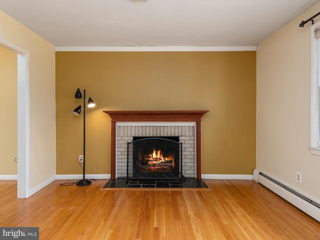 7147 Ohio Ave, Hanover, MD 21076 - room details with wood finished floors, a baseboard heating unit, baseboards, and a brick fireplace