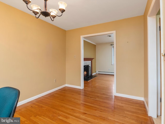 7147 Ohio Ave, Hanover, MD 21076 - unfurnished living room with baseboards, light wood finished floors, an inviting chandelier, and a baseboard heating unit