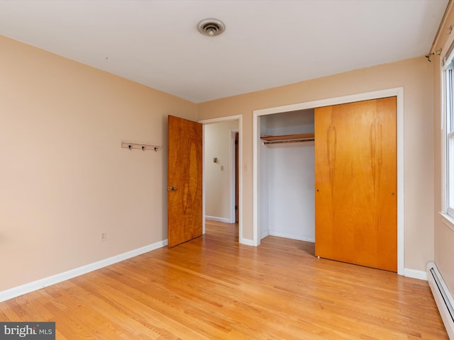 7147 Ohio Ave, Hanover, MD 21076 - unfurnished bedroom featuring light wood finished floors, a baseboard radiator, and baseboards