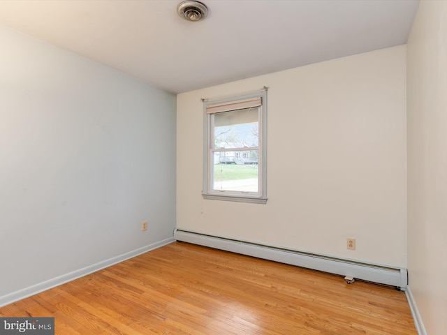 7147 Ohio Ave, Hanover, MD 21076 - unfurnished room featuring light wood finished floors, visible vents, a baseboard heating unit, and baseboards