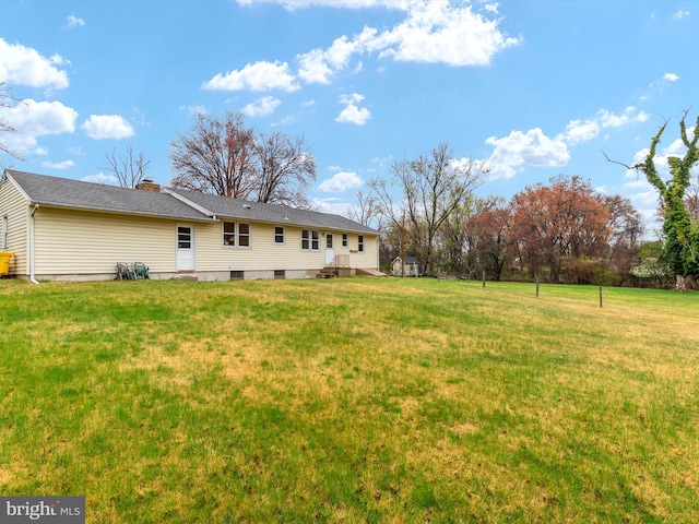 7147 Ohio Ave, Hanover, MD 21076 - back of house featuring roof with shingles, a lawn, and a chimney