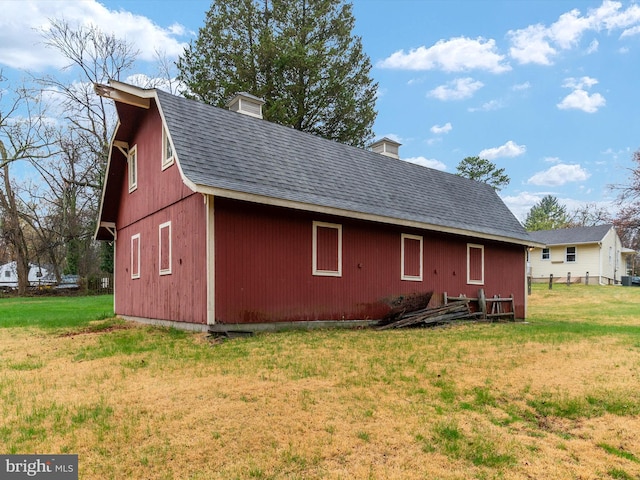 7147 Ohio Ave, Hanover, MD 21076 - back of house featuring a barn, roof with shingles, an outdoor structure, a chimney, and a lawn