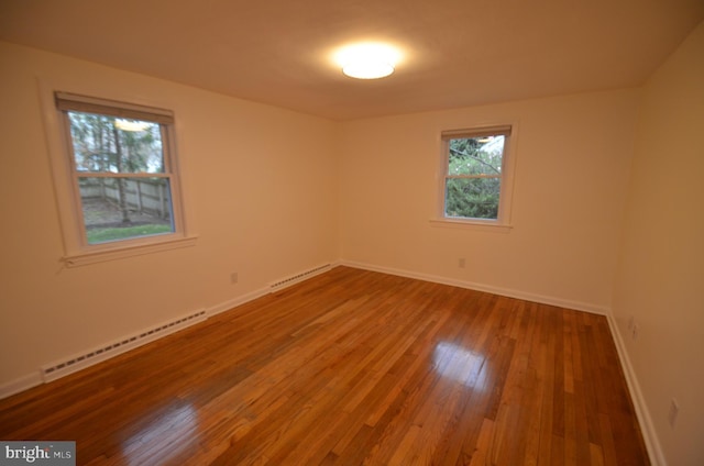 49 Wallace Rd, Princeton Junction, NJ 08550 - unfurnished room featuring wood-type flooring, a baseboard radiator, and a healthy amount of sunlight