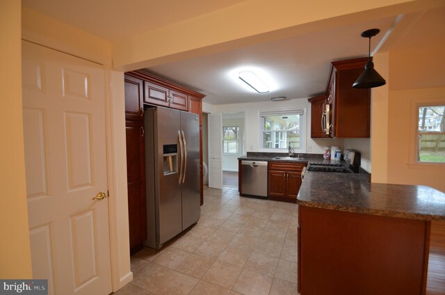 49 Wallace Rd, Princeton Junction, NJ 08550 - kitchen featuring a peninsula, light tile patterned floors, appliances with stainless steel finishes, a sink, and hanging light fixtures
