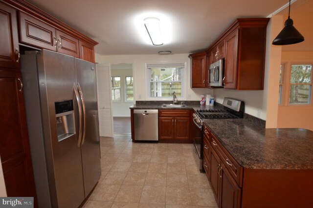49 Wallace Rd, Princeton Junction, NJ 08550 - kitchen with light tile patterned floors, decorative light fixtures, a sink, dark stone counters, and stainless steel appliances