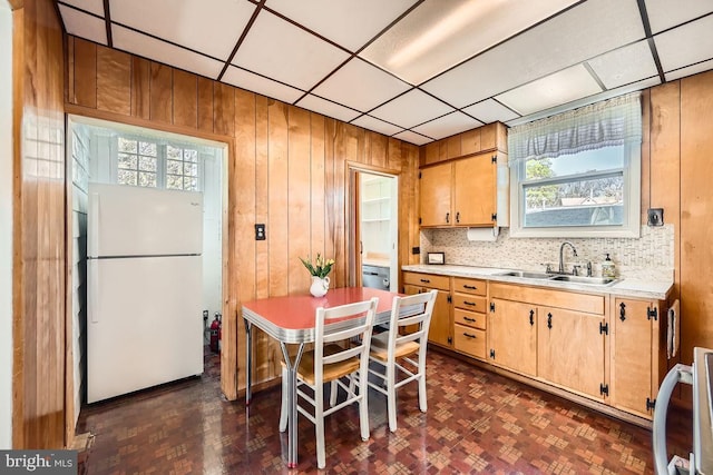 1233 Kahler Ave, Rosedale, MD 21237 - kitchen with light countertops, wooden walls, a sink, and freestanding refrigerator