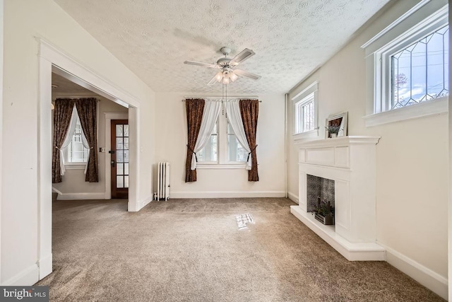 1233 Kahler Ave, Rosedale, MD 21237 - unfurnished living room featuring carpet floors, radiator heating unit, ceiling fan, and baseboards