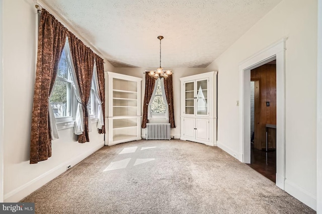 1233 Kahler Ave, Rosedale, MD 21237 - unfurnished dining area featuring baseboards, an inviting chandelier, a textured ceiling, radiator heating unit, and light colored carpet