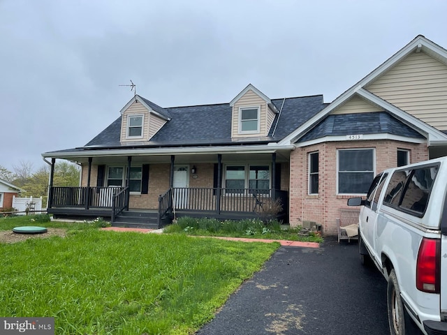 4513 Baker Valley Rd, Frederick, MD 21704 - view of front facade with brick siding, a front yard, roof with shingles, and a porch