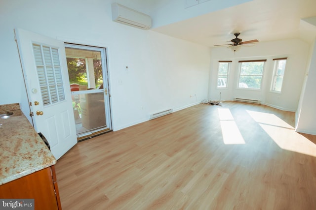 4513 Baker Valley Rd, Frederick, MD 21704 - empty room featuring a wall mounted air conditioner, healthy amount of natural light, a baseboard heating unit, and light wood-style floors