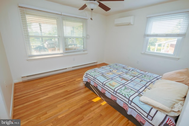 4513 Baker Valley Rd, Frederick, MD 21704 - bedroom with a wall mounted AC, a baseboard radiator, and light wood-style flooring
