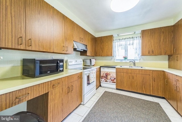 8549 Marybeth Way, Ellicott City, MD 21043 - kitchen featuring a sink, white appliances, under cabinet range hood, decorative backsplash, and light countertops