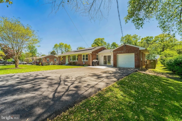 8549 Marybeth Way, Ellicott City, MD 21043 - single story home featuring brick siding, driveway, a garage, a front yard, and roof mounted solar panels