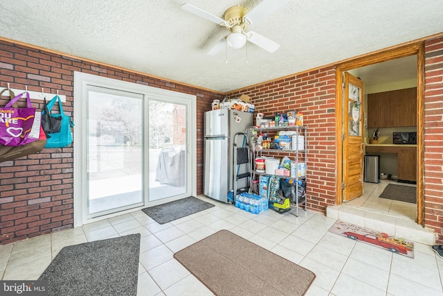 8549 Marybeth Way, Ellicott City, MD 21043 - doorway to outside featuring tile patterned floors, brick wall, ceiling fan, and a textured ceiling