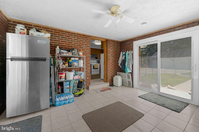 8549 Marybeth Way, Ellicott City, MD 21043 - interior space with a textured ceiling, tile patterned flooring, a ceiling fan, and brick wall