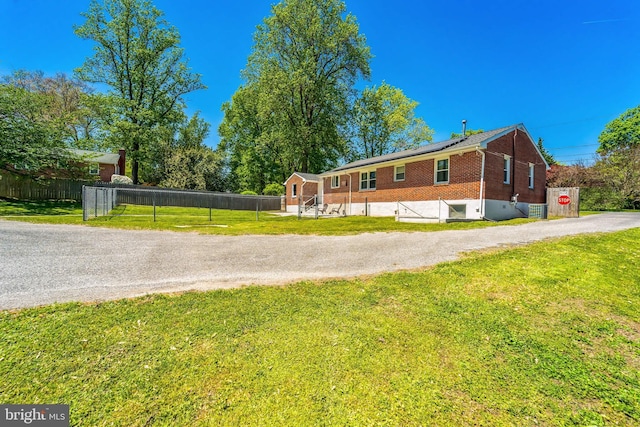 8549 Marybeth Way, Ellicott City, MD 21043 - view of property exterior featuring a lawn, driveway, brick siding, fence, and solar panels