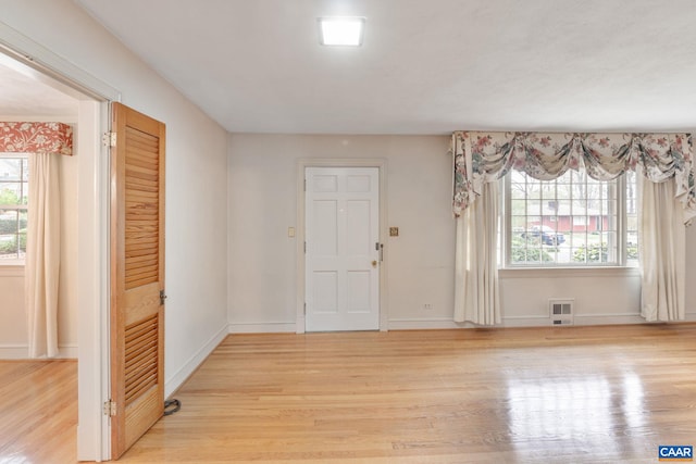 foyer entrance with light wood-type flooring and baseboards