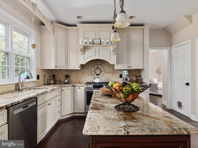 kitchen featuring decorative backsplash, light stone countertops, stainless steel appliances, and dark wood-style flooring