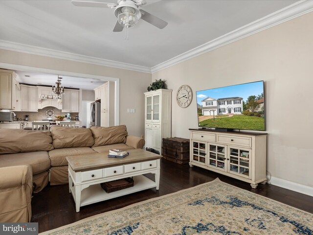 living area featuring crown molding, baseboards, ceiling fan with notable chandelier, and dark wood-style flooring
