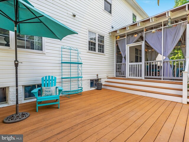 wooden deck featuring a sunroom