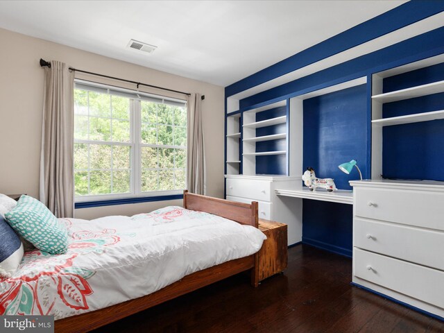 bedroom with visible vents and dark wood-type flooring