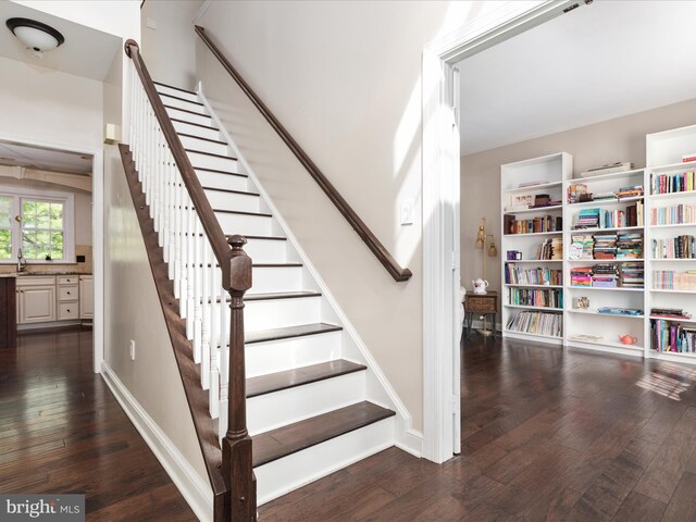 staircase with baseboards and hardwood / wood-style flooring