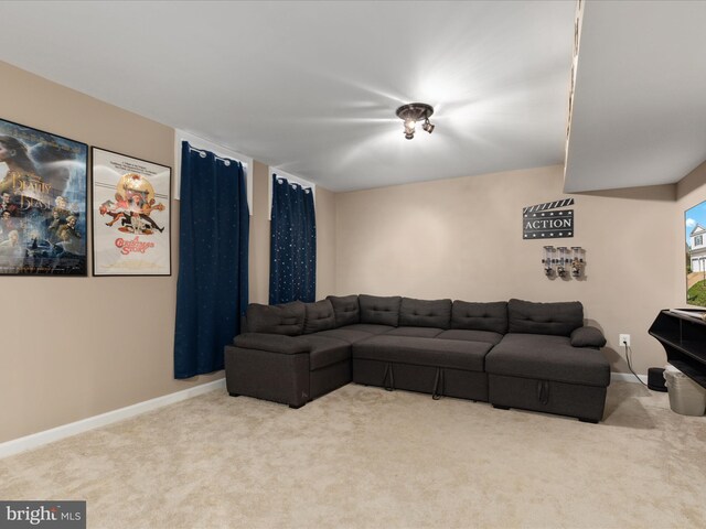 carpeted living room with baseboards