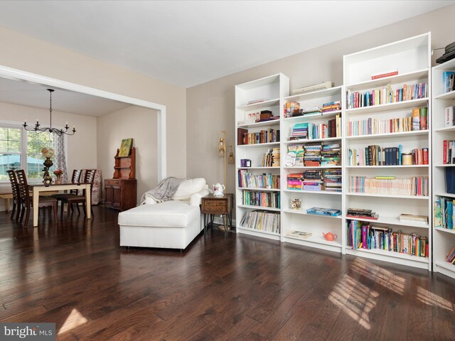 sitting room with a notable chandelier and hardwood / wood-style flooring