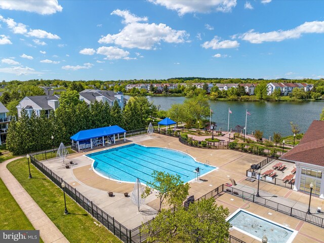 pool with a water view and fence
