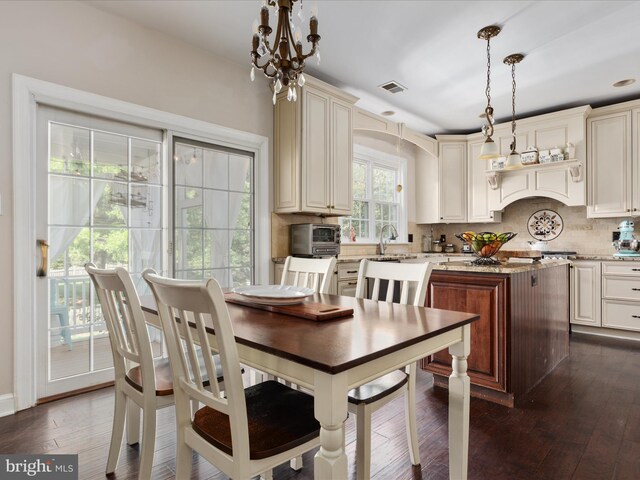 interior space featuring a toaster, arched walkways, dark wood-style flooring, and visible vents
