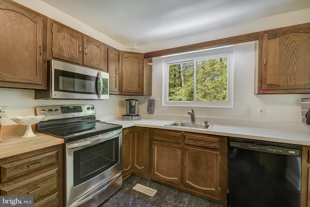 kitchen featuring a sink, light countertops, and stainless steel appliances