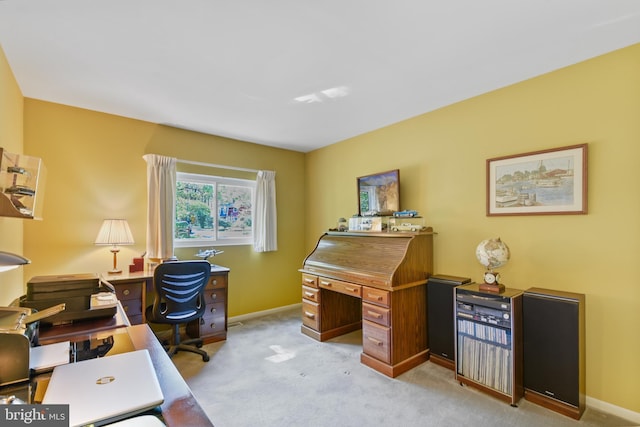 office featuring baseboards and light carpet